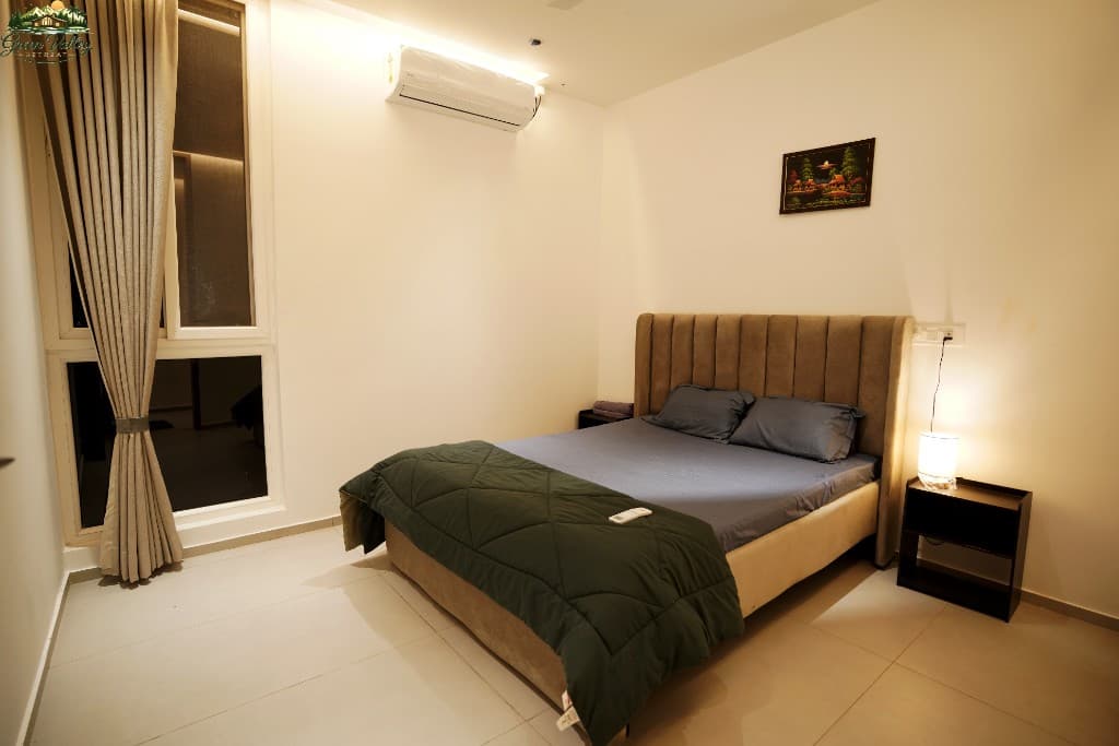 Comfortable bedroom with warm lamp and garden view