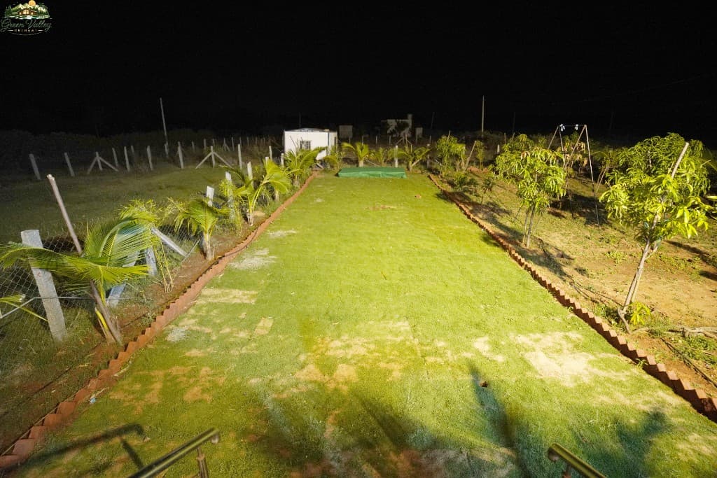 Aerial view of the manicured garden and farm grounds at night